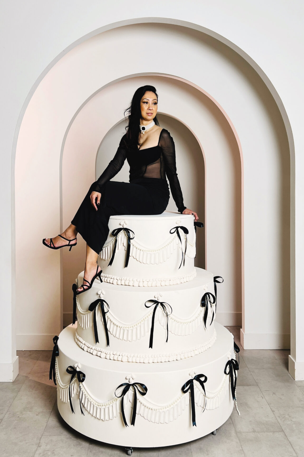 Monet Studios - The Monet Cake - Person on top of Cake